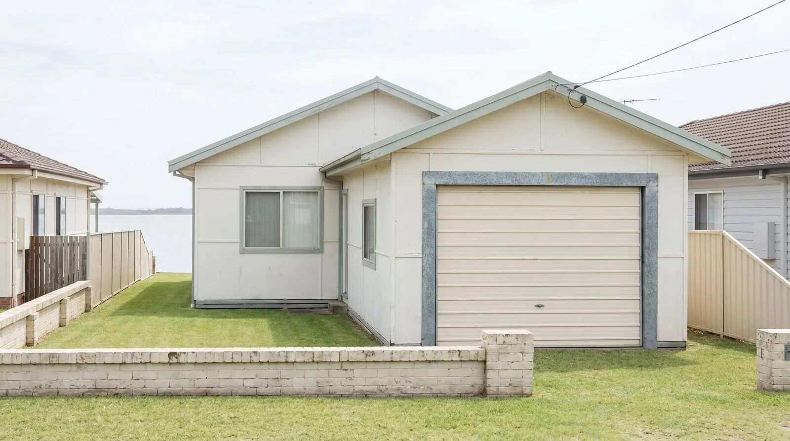 A mid-century fibro cottage with its original tilt garage door