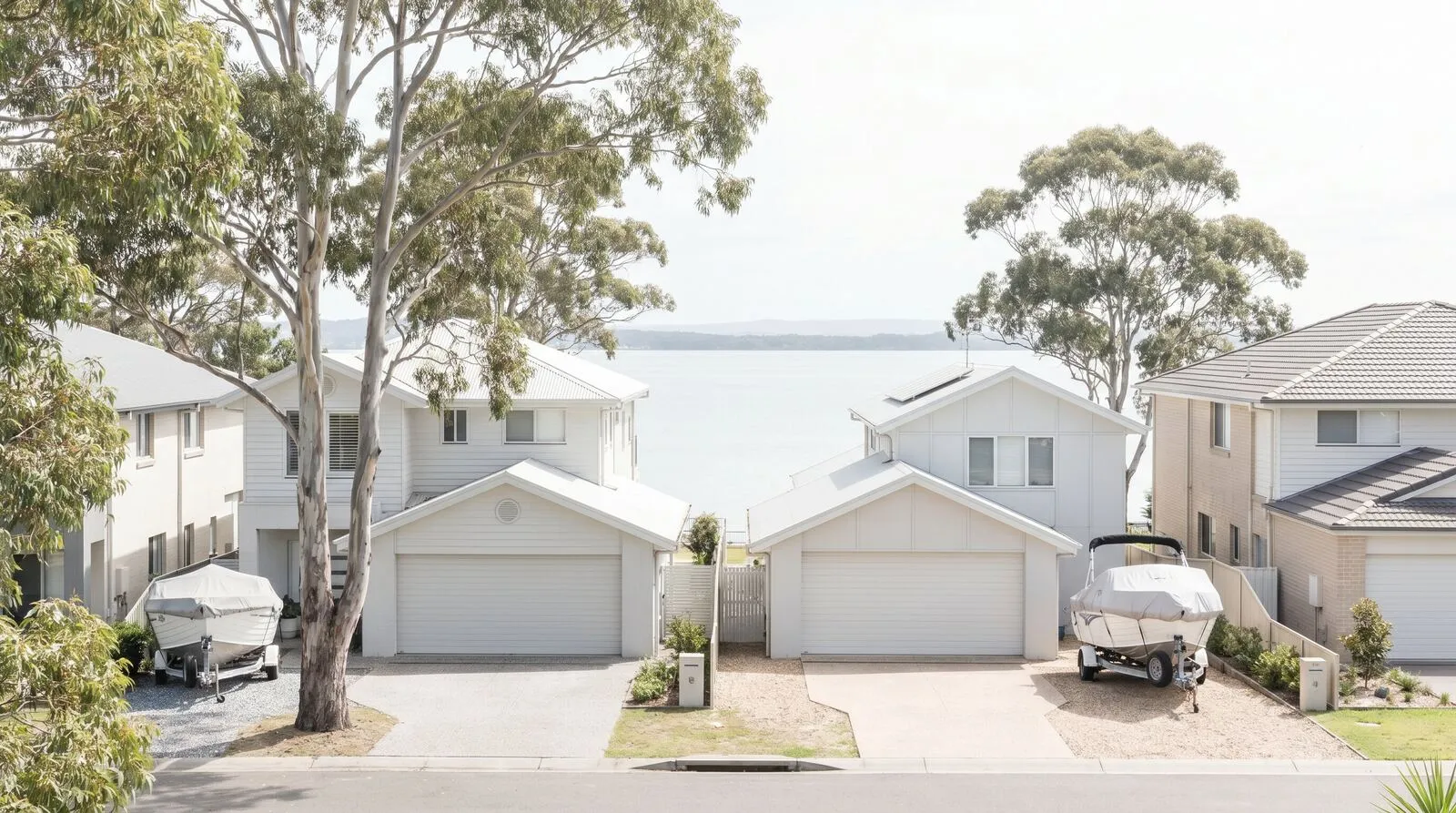 A leafy Valentine street with boats on trailers in driveways
